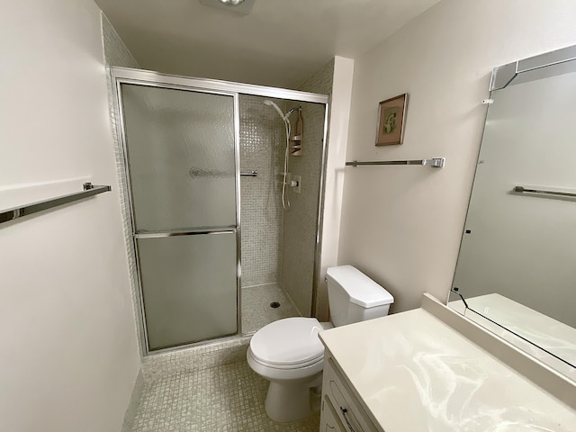 bathroom with vanity, toilet, and a shower with shower door