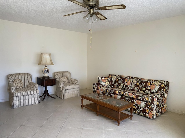 tiled living room with ceiling fan and a textured ceiling