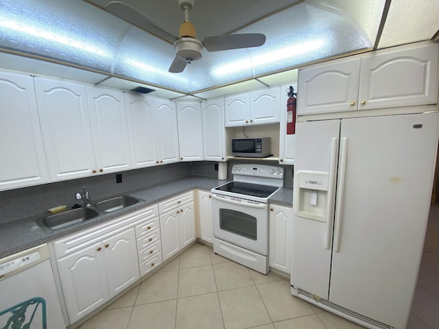 kitchen featuring white cabinetry, sink, light tile patterned floors, ceiling fan, and white appliances