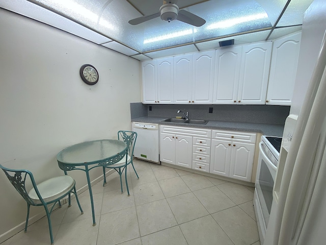 kitchen featuring sink, light tile patterned floors, white cabinets, and white appliances