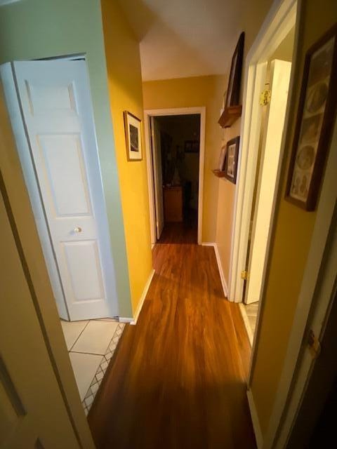 hallway with hardwood / wood-style floors