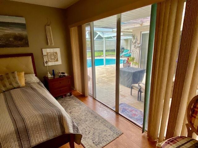 bedroom with access to outside and light hardwood / wood-style floors