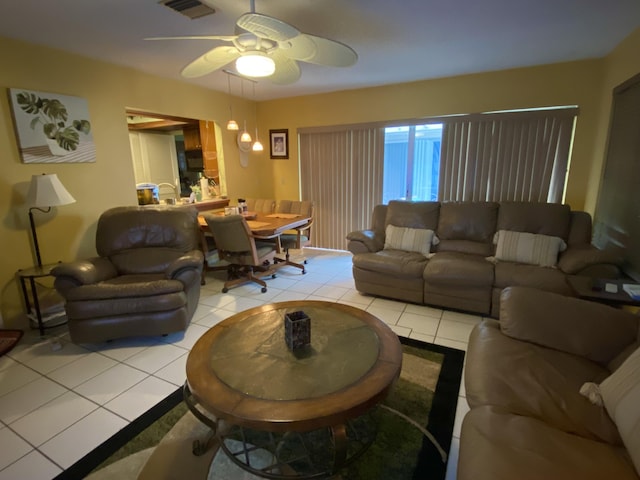 tiled living room with ceiling fan