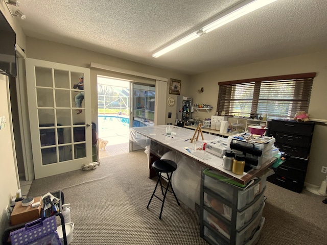 interior space featuring a breakfast bar, a textured ceiling, and carpet