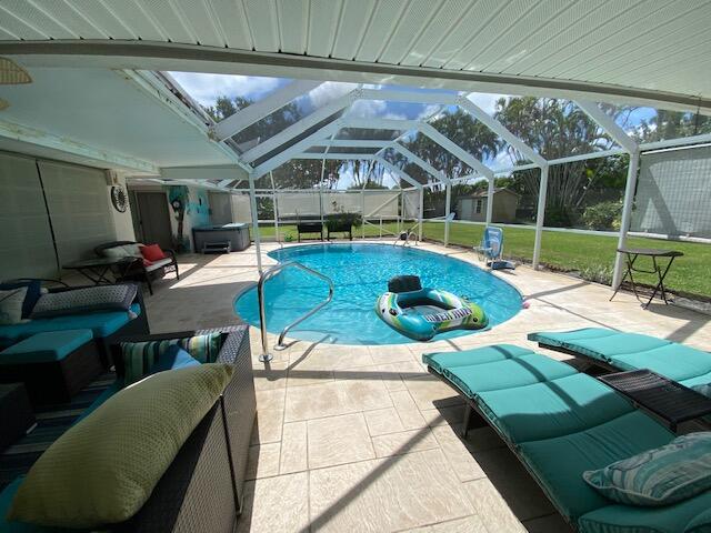 view of pool featuring a patio, a lanai, an outdoor hangout area, and a yard