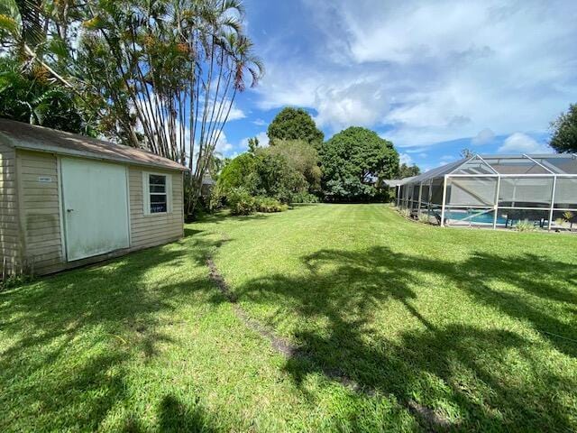 view of yard featuring a storage shed and a lanai