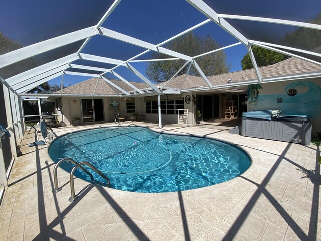 2086 SE Bisbee St, Port Saint Lucie, FL 34952 - outdoor pool featuring a lanai, a patio, and a hot tub