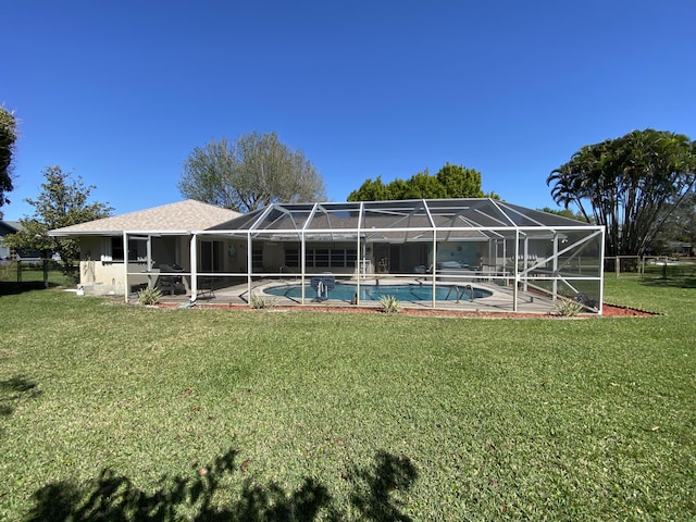 back of house with a lanai, a yard, an outdoor pool, and a patio