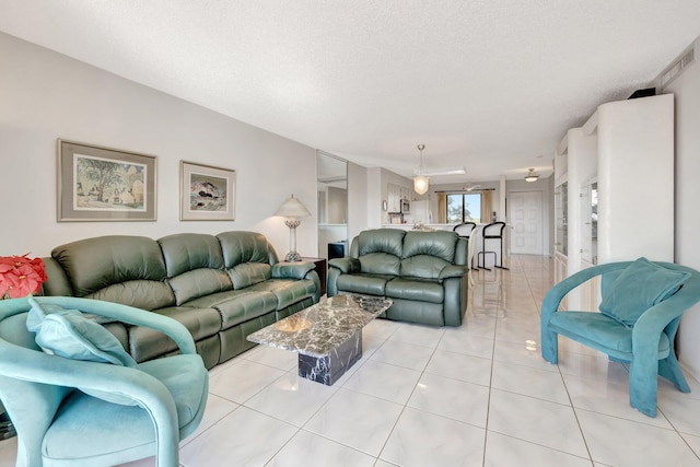 tiled living room with a textured ceiling