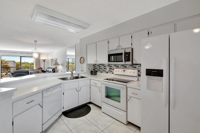 kitchen featuring sink, white cabinets, decorative backsplash, white appliances, and a textured ceiling