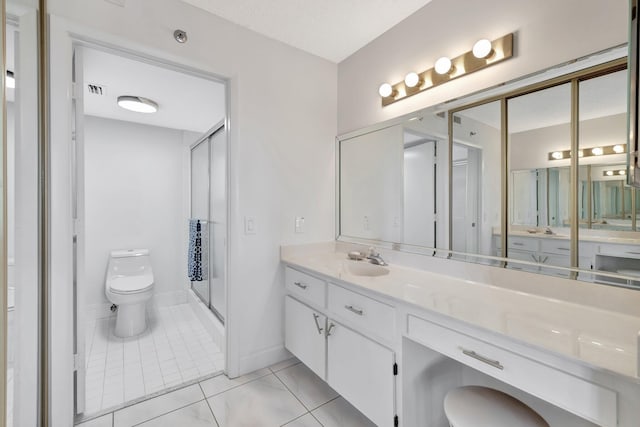 bathroom featuring walk in shower, vanity, toilet, and tile patterned flooring