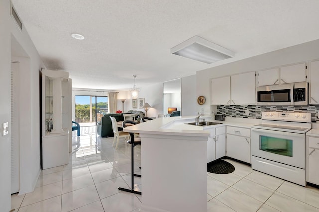 kitchen featuring electric range, kitchen peninsula, and white cabinets