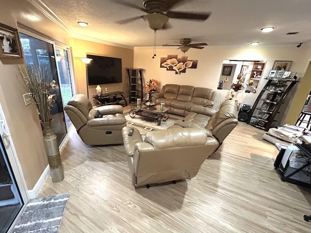 living room with hardwood / wood-style flooring, crown molding, ceiling fan, and a textured ceiling