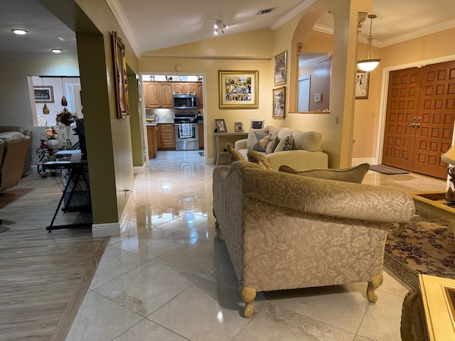 living room featuring ornamental molding and vaulted ceiling