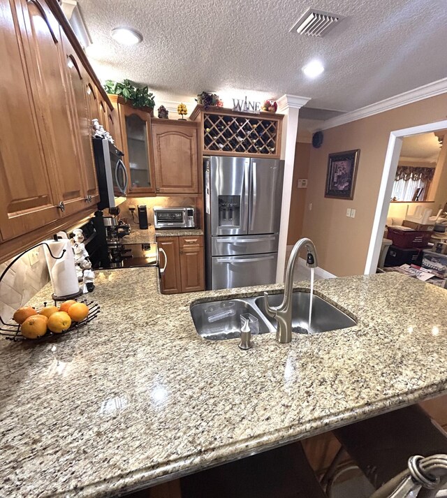 kitchen featuring light tile patterned flooring, stainless steel appliances, and light stone countertops