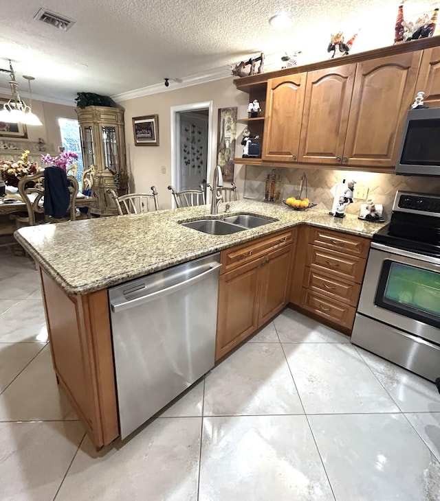 kitchen featuring crown molding, appliances with stainless steel finishes, sink, and kitchen peninsula