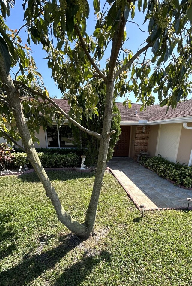 view of side of property with a garage and a lawn