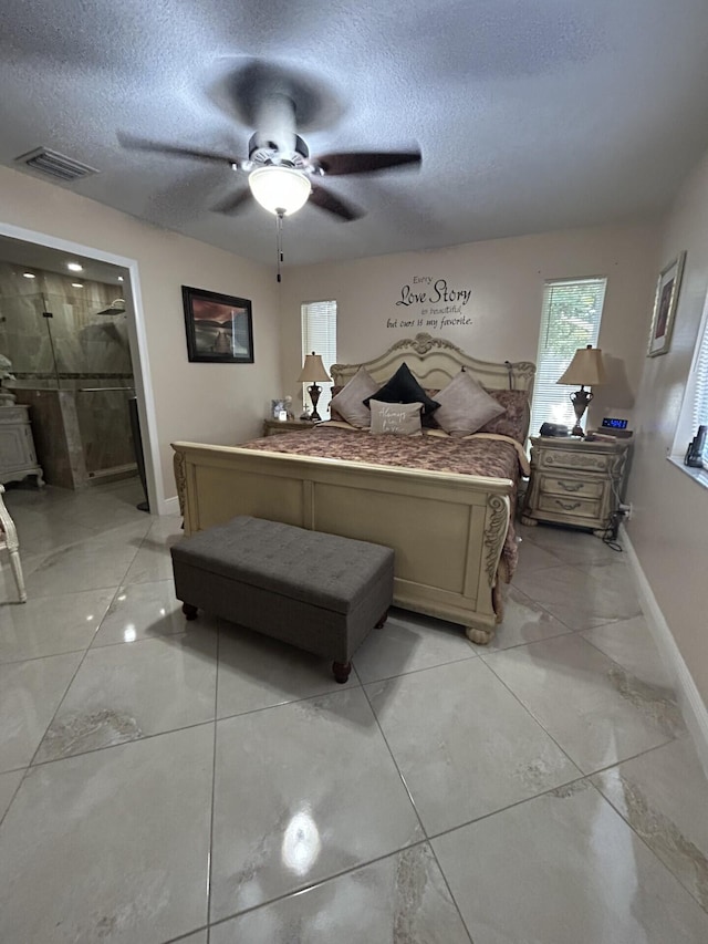 bedroom featuring ceiling fan, a textured ceiling, and ensuite bath