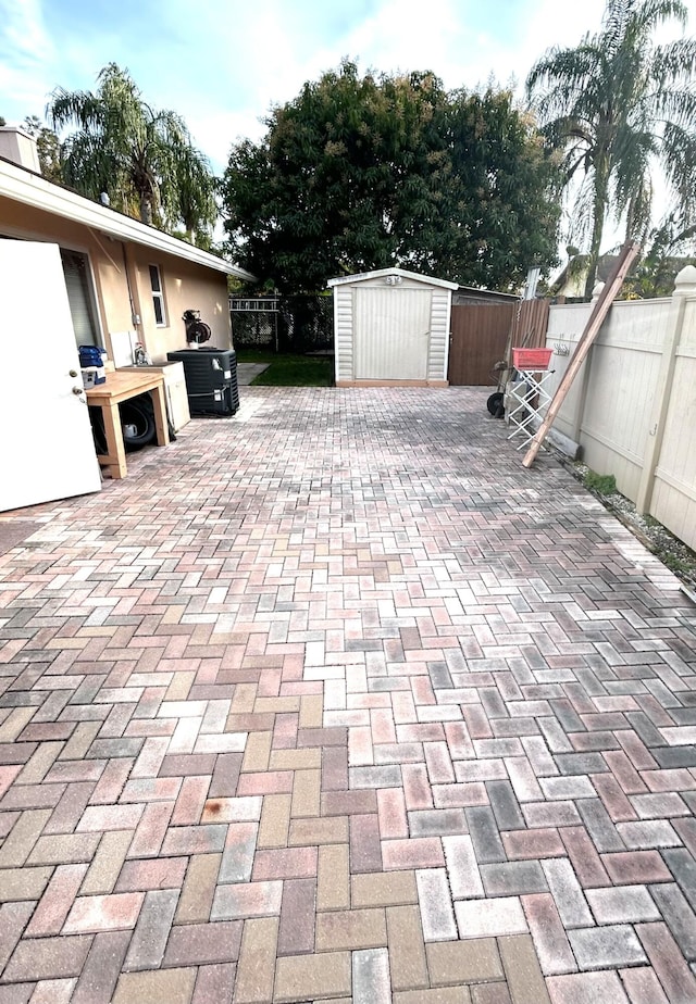 view of patio featuring a shed