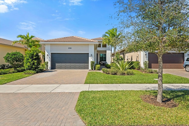 view of front of property with a garage and a front yard