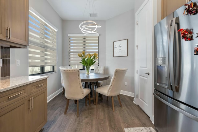 dining area featuring an inviting chandelier and dark hardwood / wood-style floors