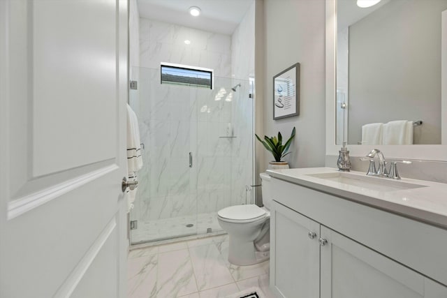 bathroom featuring vanity, toilet, and a shower with door