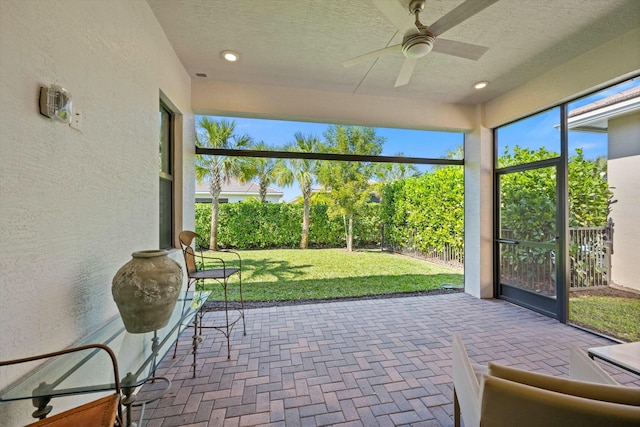 sunroom featuring ceiling fan