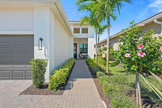 view of exterior entry with a garage