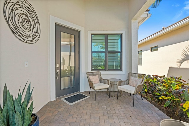 entrance to property featuring a patio