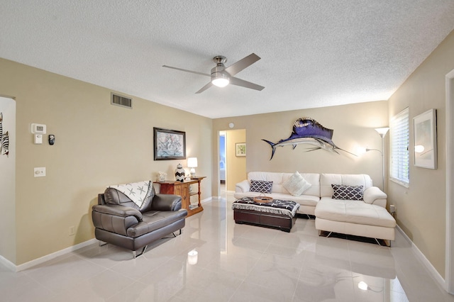 living room with baseboards, visible vents, a textured ceiling, and ceiling fan