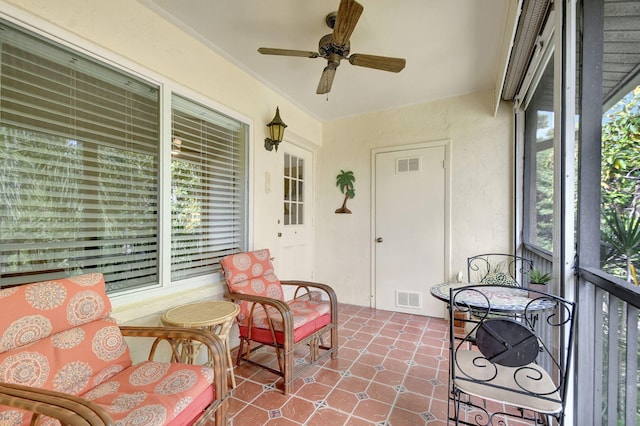 sunroom with visible vents and a ceiling fan