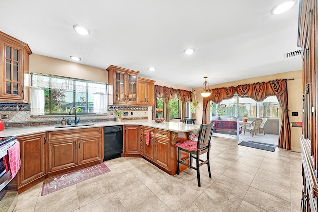 kitchen with a breakfast bar, decorative light fixtures, sink, electric range, and kitchen peninsula