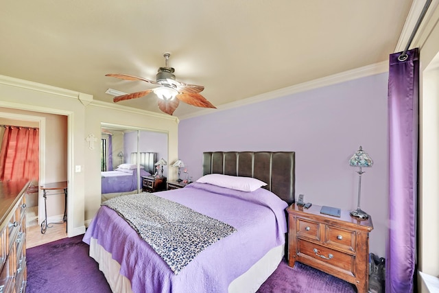 bedroom featuring crown molding, dark carpet, ceiling fan, and a closet