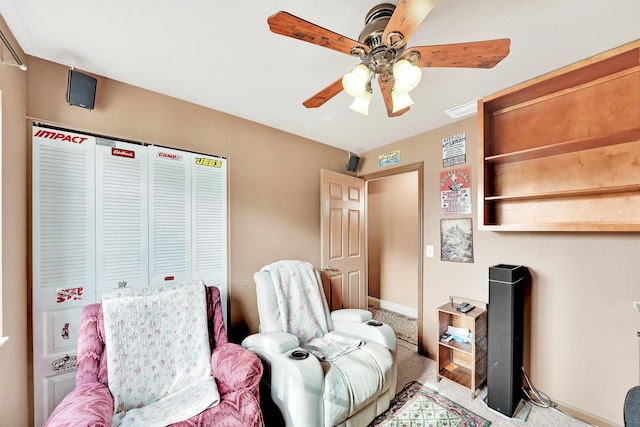 carpeted bedroom featuring ceiling fan and a closet