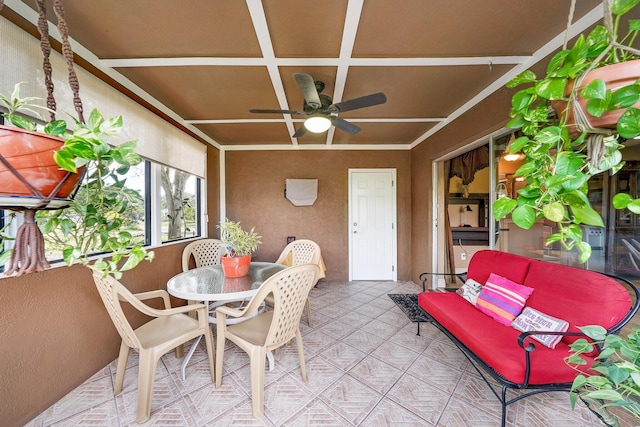 sunroom / solarium featuring coffered ceiling and ceiling fan