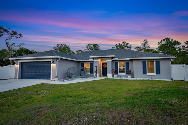 view of front of house featuring a garage and a yard