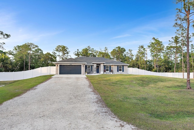 ranch-style house featuring a garage and a front lawn