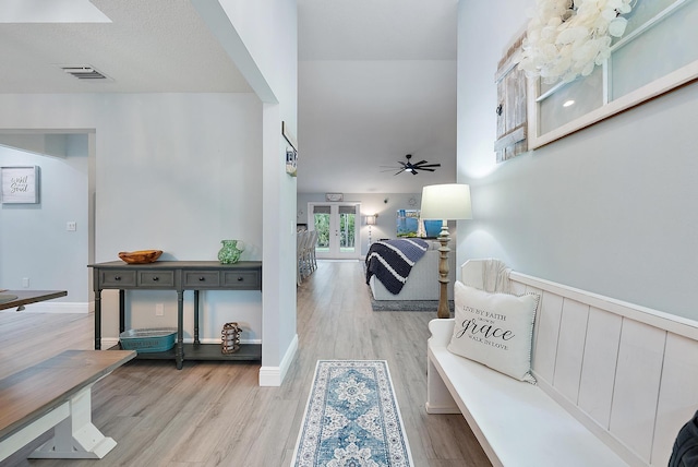 hall featuring french doors and light hardwood / wood-style flooring