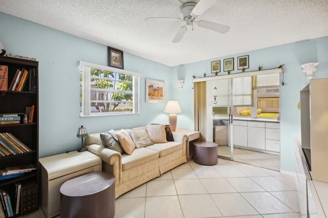 tiled living room with ceiling fan and a textured ceiling