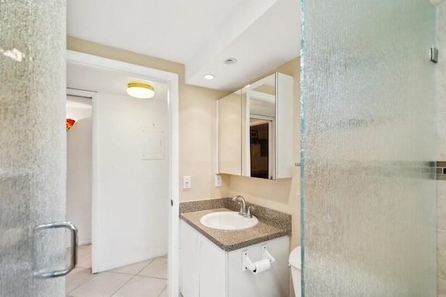 bathroom with vanity, tile patterned floors, and a shower with shower door