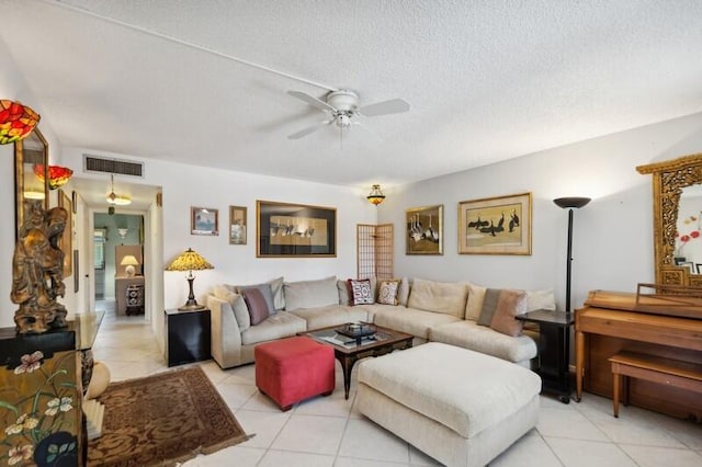 tiled living room featuring ceiling fan and a textured ceiling