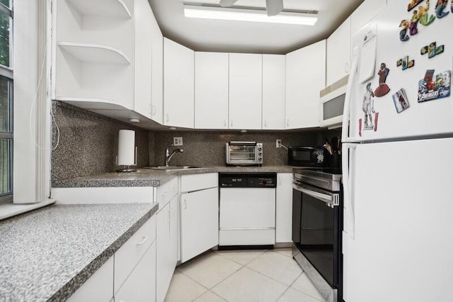 kitchen featuring light tile patterned flooring, white cabinetry, sink, decorative backsplash, and white appliances