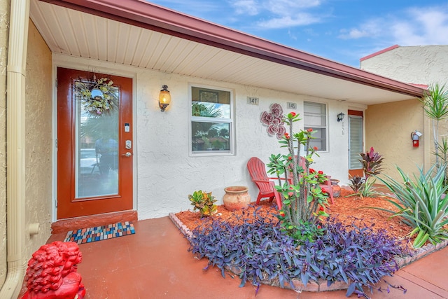 entrance to property with stucco siding