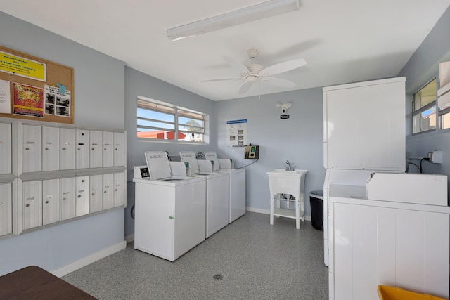 shared laundry area featuring mail area, a ceiling fan, a sink, baseboards, and washing machine and clothes dryer