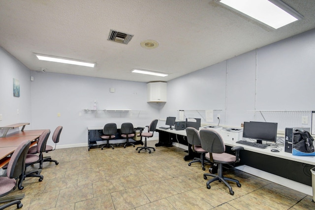 office space featuring visible vents and a textured ceiling