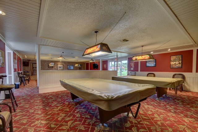 playroom featuring visible vents, a textured ceiling, wainscoting, and carpet flooring