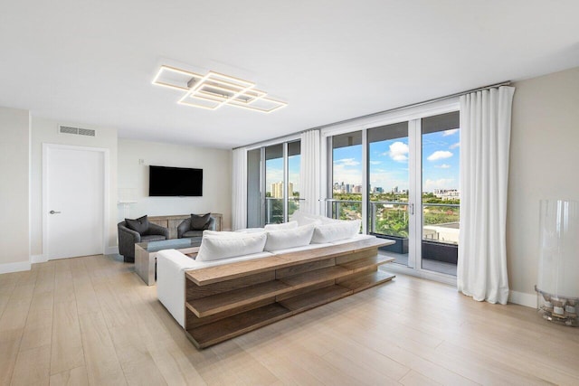 living room featuring light hardwood / wood-style floors and expansive windows