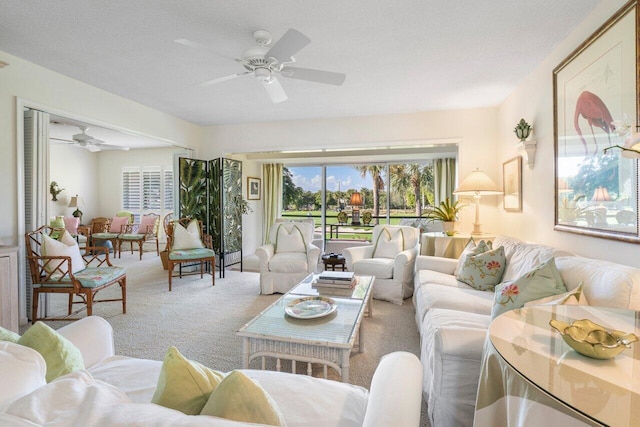 living room with ceiling fan and carpet