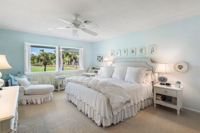 carpeted bedroom featuring a textured ceiling and ceiling fan