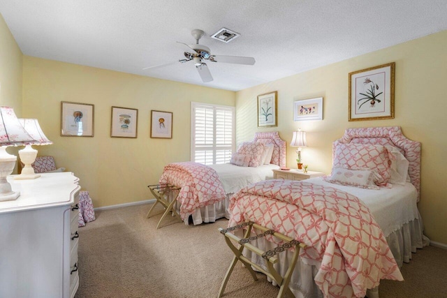 carpeted bedroom with a textured ceiling and ceiling fan